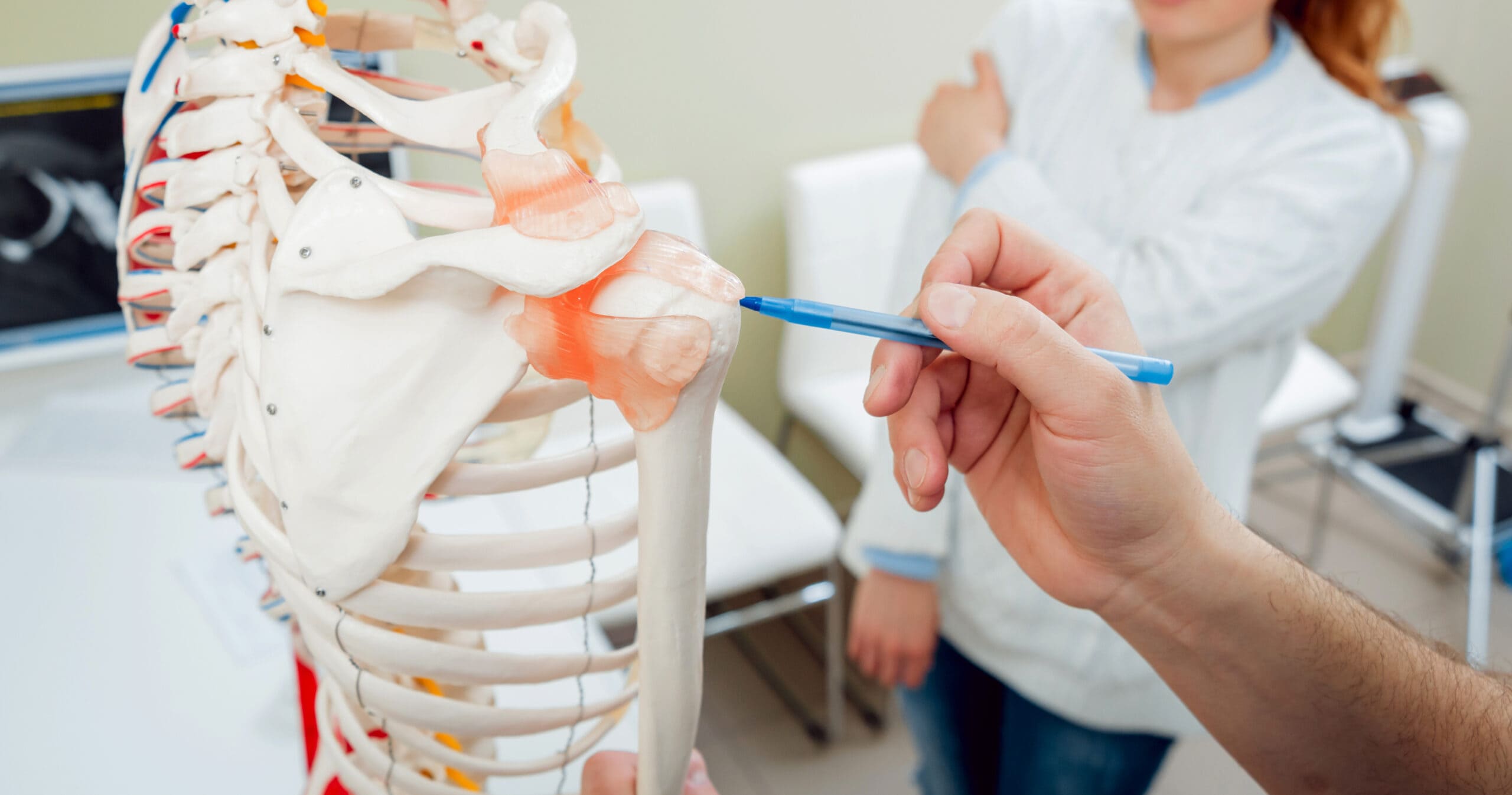 Patient with orthopedist doctor in his office.